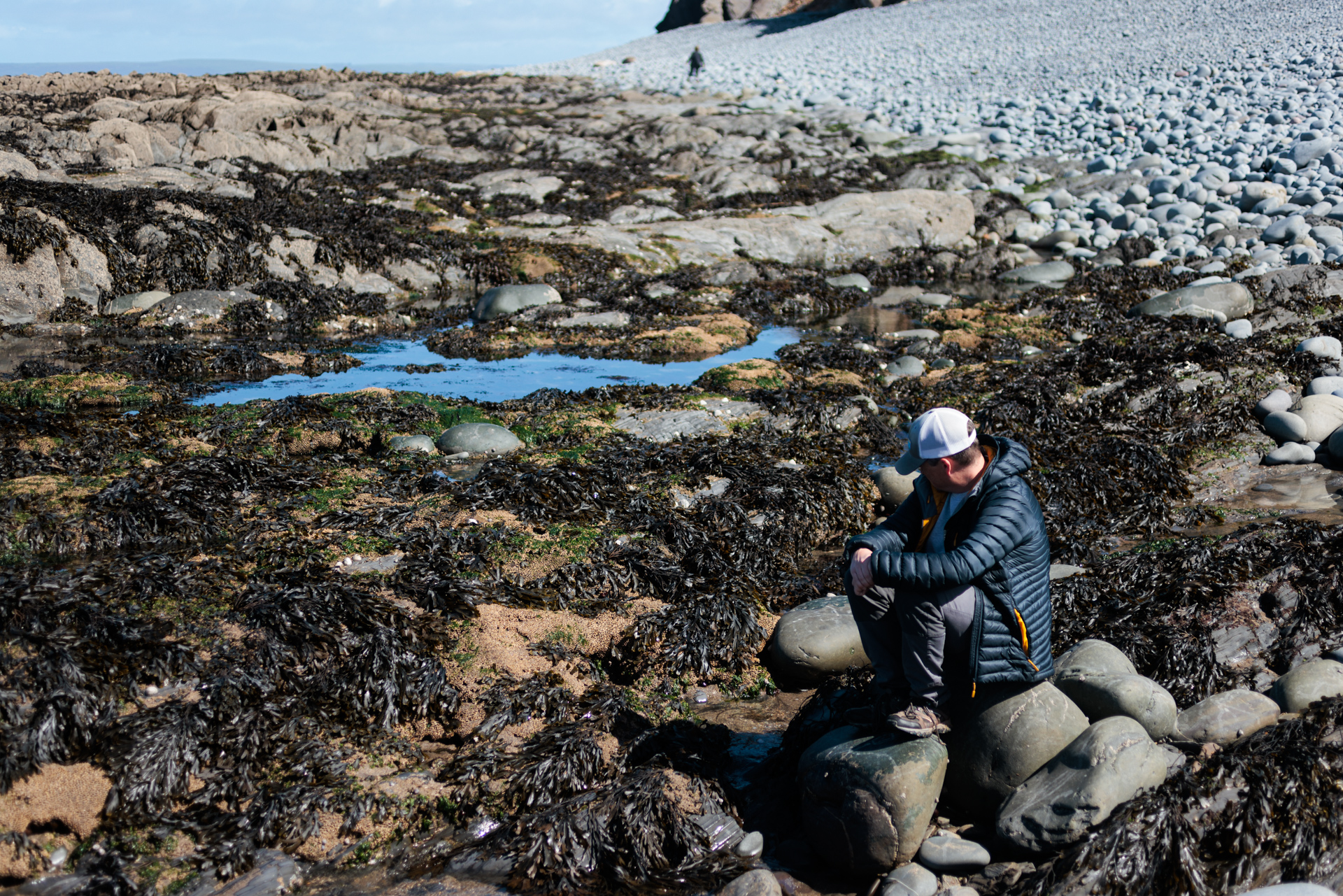 A man sits peacefully and contemplates the natural world around him